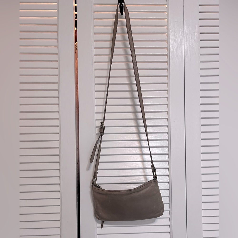 HOBO cross body, taupe color. Zipper top closure with adjustable strap.